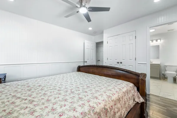 a bedroom with a bed and a chandelier