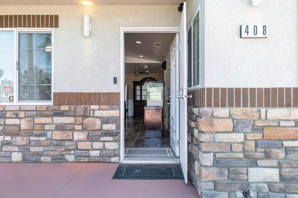 a view of front door of house with stairs