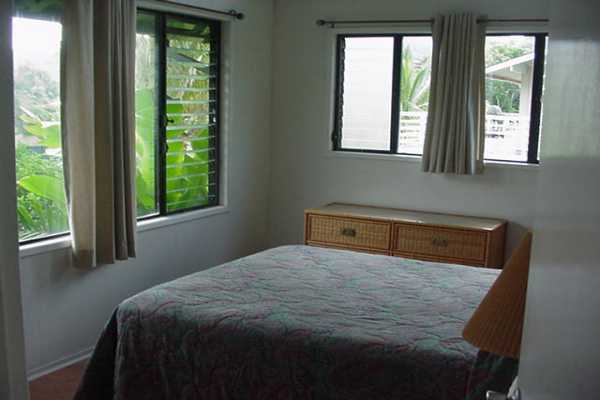 4386 Hee Road Hanalei, HI 96714 - Photo 11 of 28 a bedroom with a bed and windows