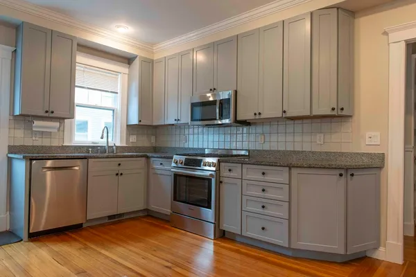 a kitchen with wooden floors and a granite counter tops