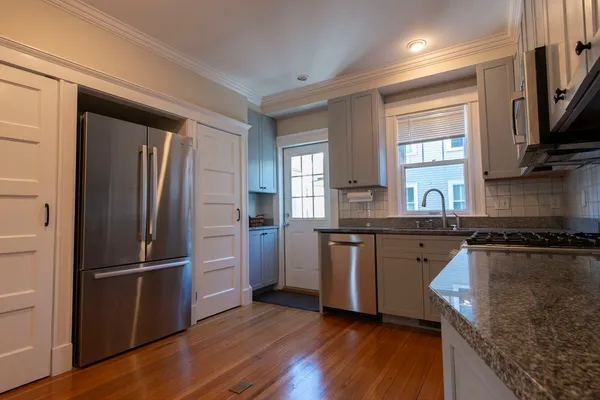 a view of interior space with wooden floor and large window