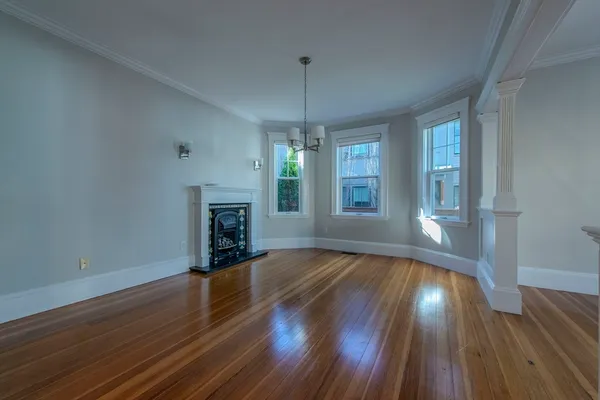 a view of a room with wooden floor and cabinet