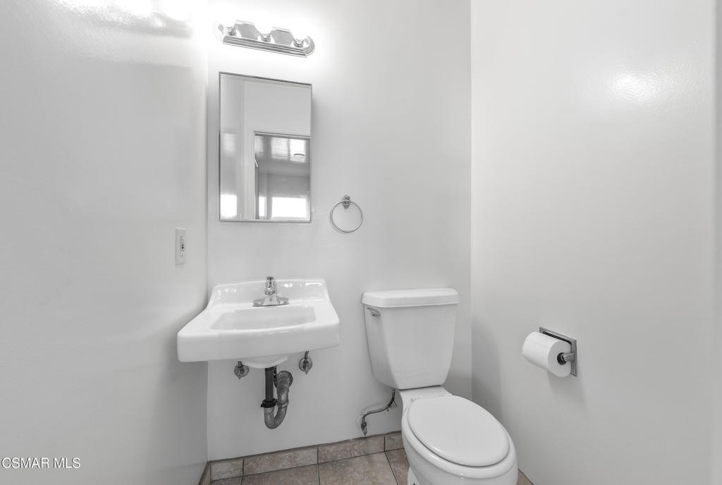 22002 Ybarra Road Woodland Hills, CA 91364 - Photo 22 of 31 a bathroom with a sink toilet and mirror