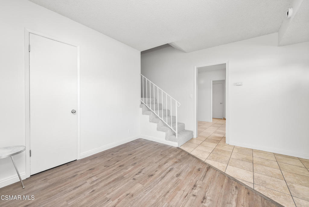 22002 Ybarra Road Woodland Hills, CA 91364 - Photo 9 of 31 a view of a hallway with wooden floor and entryway
