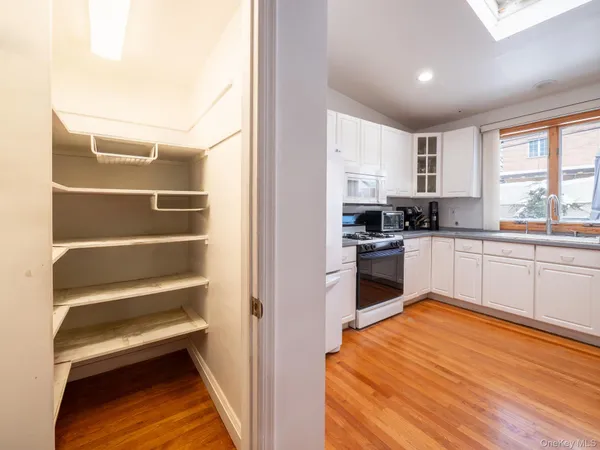 a kitchen with stainless steel appliances cabinets a sink and a window