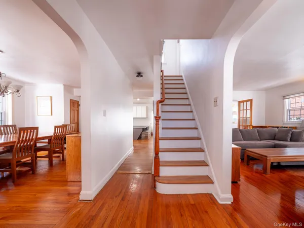a view of a living room and dining room with wooden floor