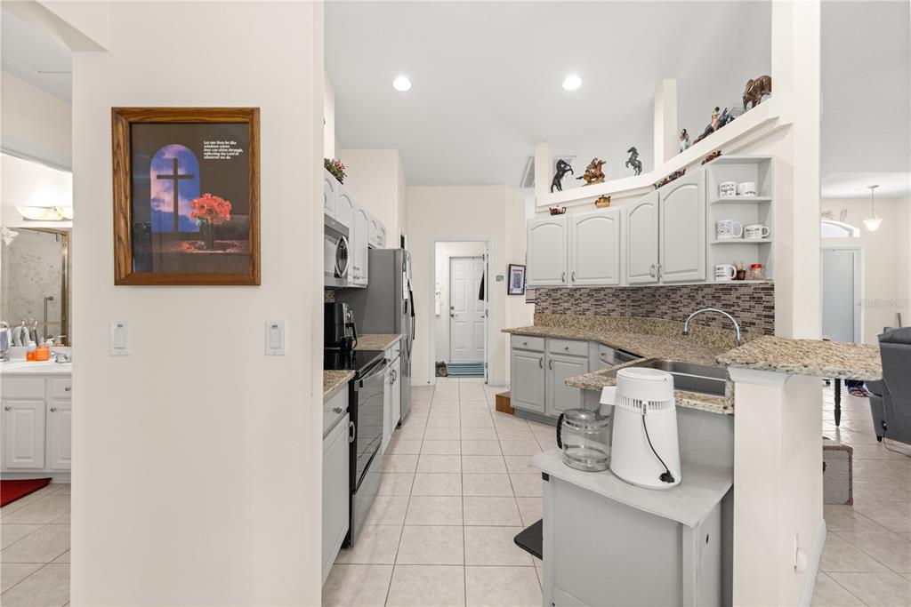 8601 Southwest 60th Circle Ocala, FL 34476 - Photo 14 of 45 a spacious bathroom with a granite countertop sink a mirror and shower