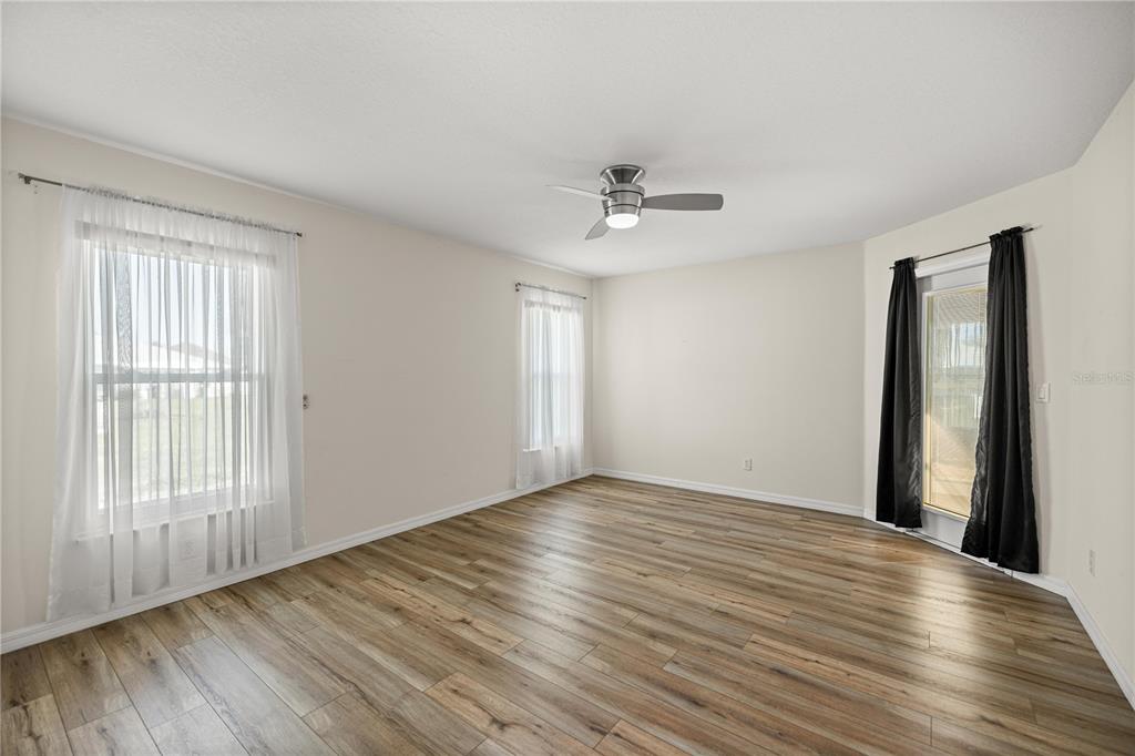 8601 Southwest 60th Circle Ocala, FL 34476 - Photo 16 of 37 a view of an empty room with wooden floor and a window