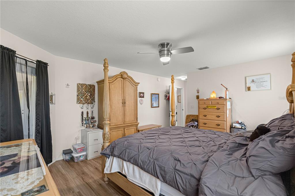 8601 Southwest 60th Circle Ocala, FL 34476 - Photo 18 of 45 a bedroom with a bed dresser and a large mirror