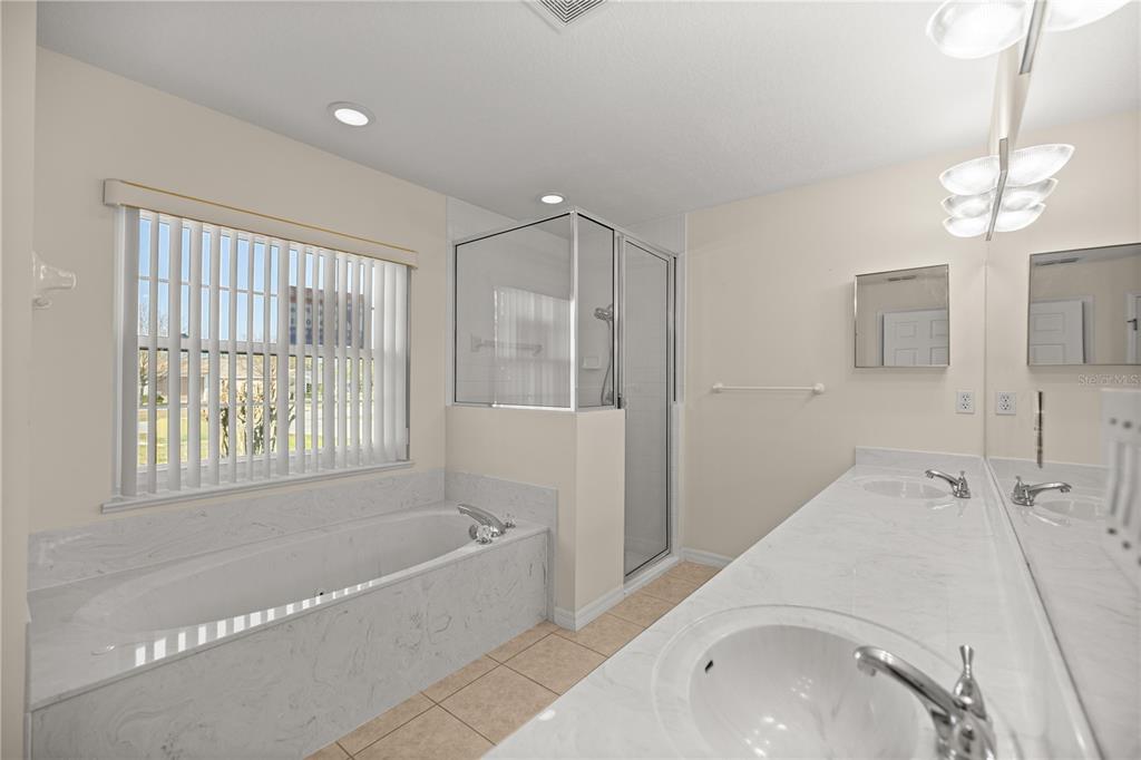 8601 Southwest 60th Circle Ocala, FL 34476 - Photo 19 of 37 a bathroom with a bathtub and a shower