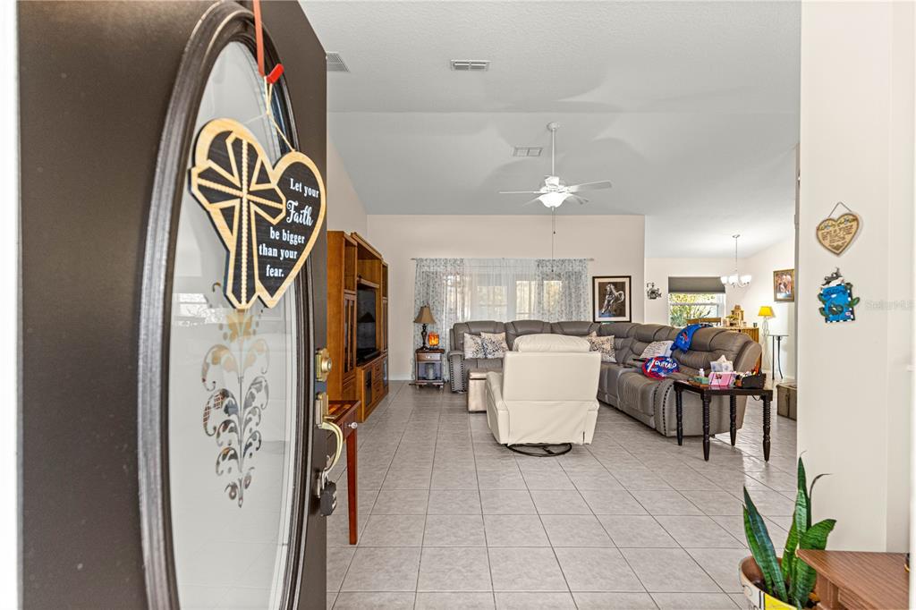 8601 Southwest 60th Circle Ocala, FL 34476 - Photo 2 of 45 a view of living room with a white house and a refrigerator