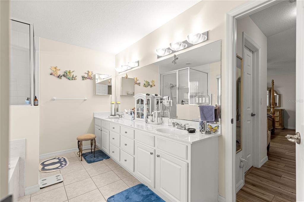 8601 Southwest 60th Circle Ocala, FL 34476 - Photo 21 of 45 a spacious bathroom with a double vanity sink a mirror and a shower