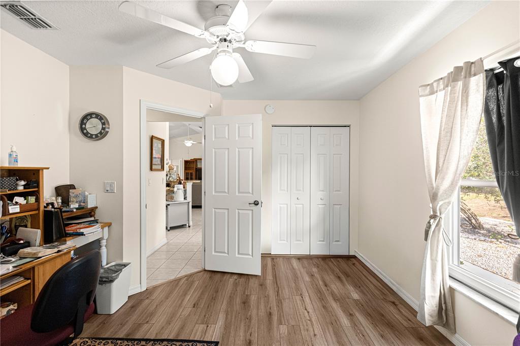 8601 Southwest 60th Circle Ocala, FL 34476 - Photo 23 of 45 a view of a livingroom with wooden floor and a ceiling fan