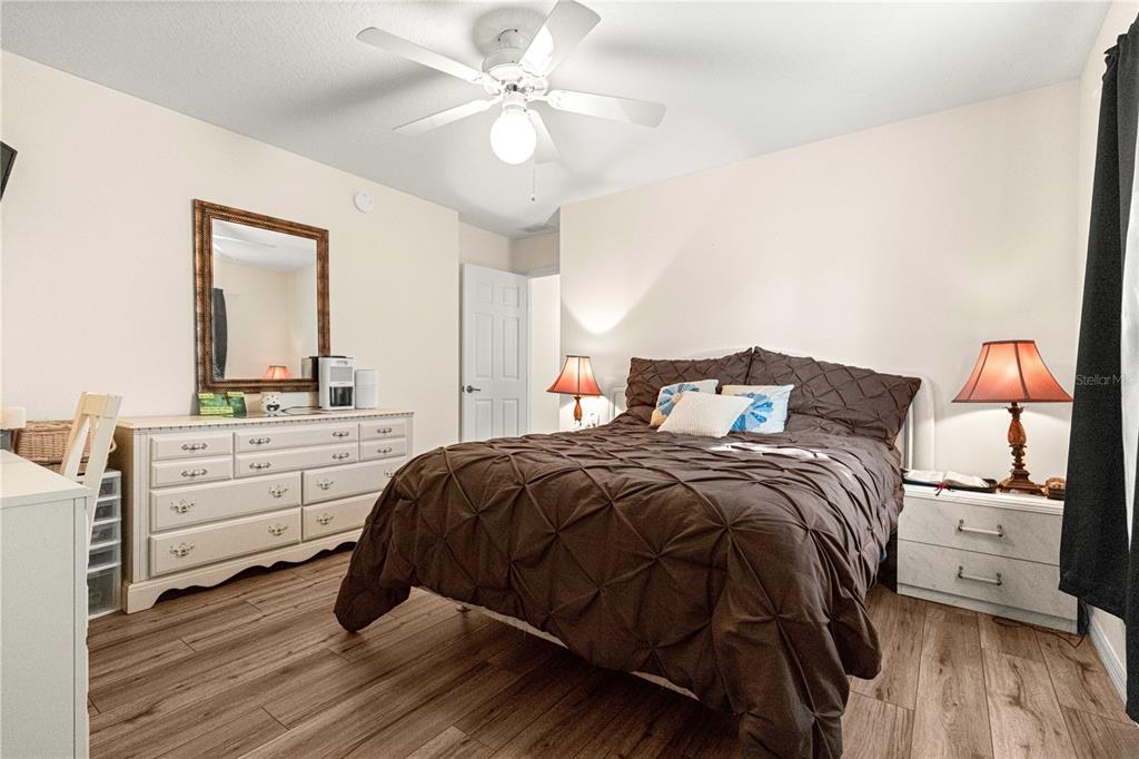 8601 Southwest 60th Circle Ocala, FL 34476 - Photo 24 of 45 a bedroom with a bed and a chandelier