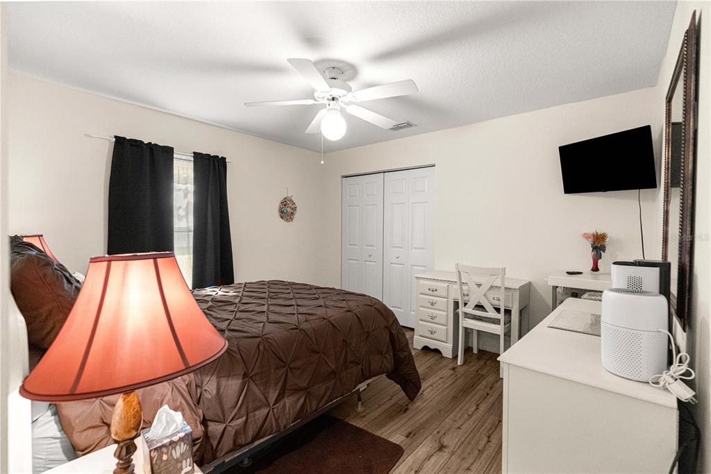 8601 Southwest 60th Circle Ocala, FL 34476 - Photo 25 of 45 a bedroom with a bed and a flat screen tv