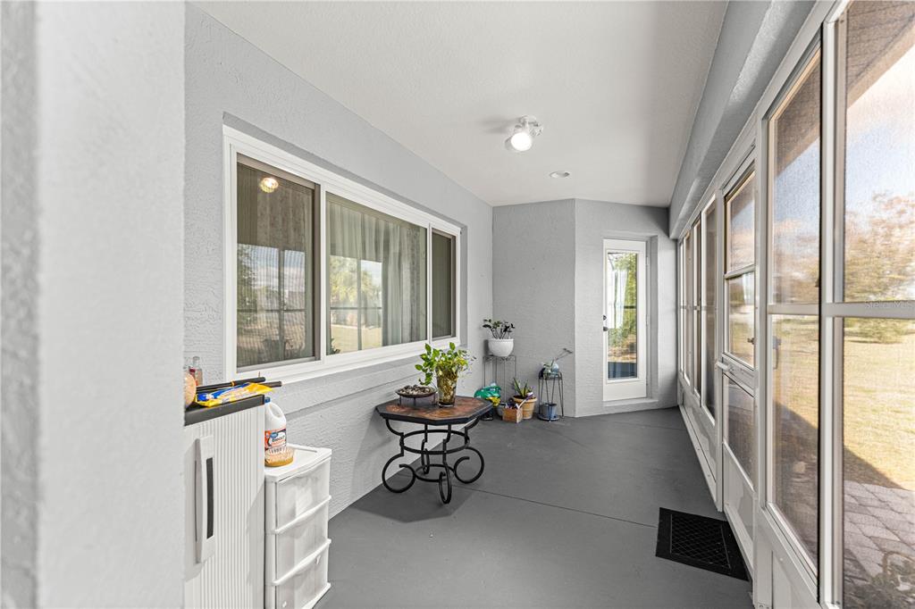 8601 Southwest 60th Circle Ocala, FL 34476 - Photo 27 of 45 a living room with furniture and a table next to a large window