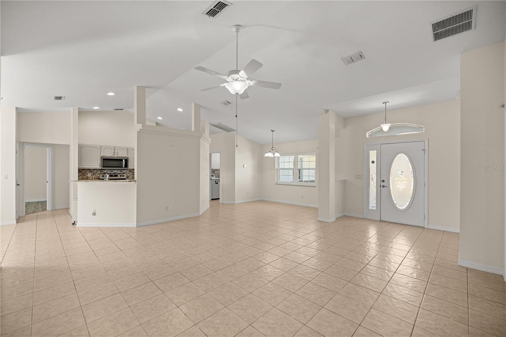 8601 Southwest 60th Circle Ocala, FL 34476 - Photo 3 of 37 a view of a kitchen with a kitchen island white cabinets and stainless steel appliances