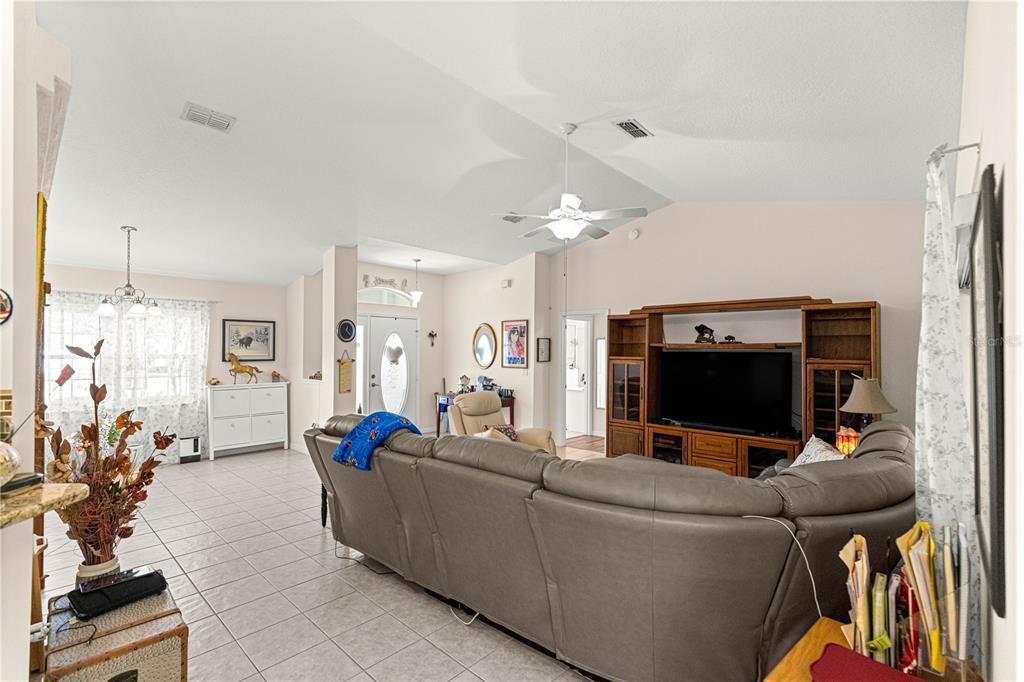 8601 Southwest 60th Circle Ocala, FL 34476 - Photo 5 of 45 a living room with furniture and a flat screen tv