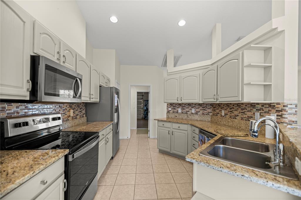 8601 Southwest 60th Circle Ocala, FL 34476 - Photo 6 of 37 a kitchen with a sink stove and microwave