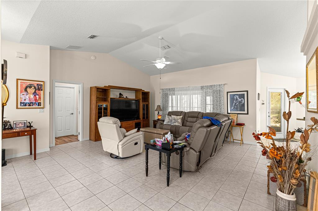 8601 Southwest 60th Circle Ocala, FL 34476 - Photo 7 of 45 a living room with furniture and a flat screen tv