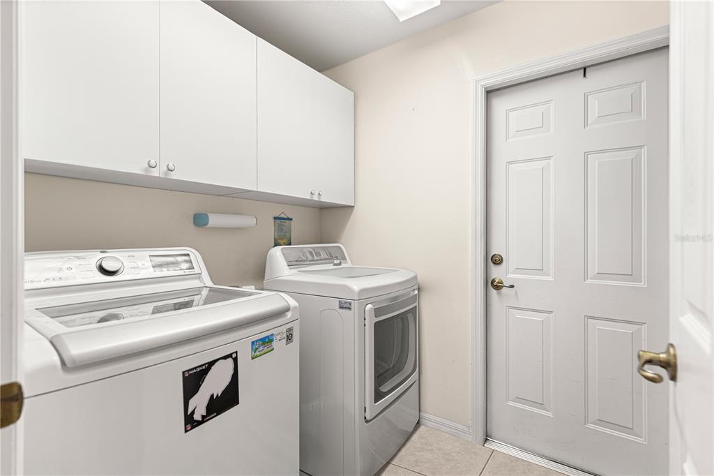 8601 Southwest 60th Circle Ocala, FL 34476 - Photo 10 of 45 a view of washer and dryer with kitchen in the background