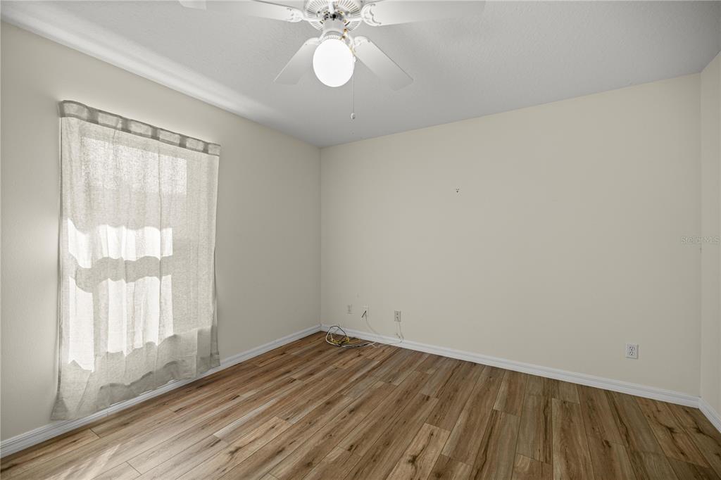 8601 Southwest 60th Circle Ocala, FL 34476 - Photo 10 of 37 wooden floor in an empty room with a window