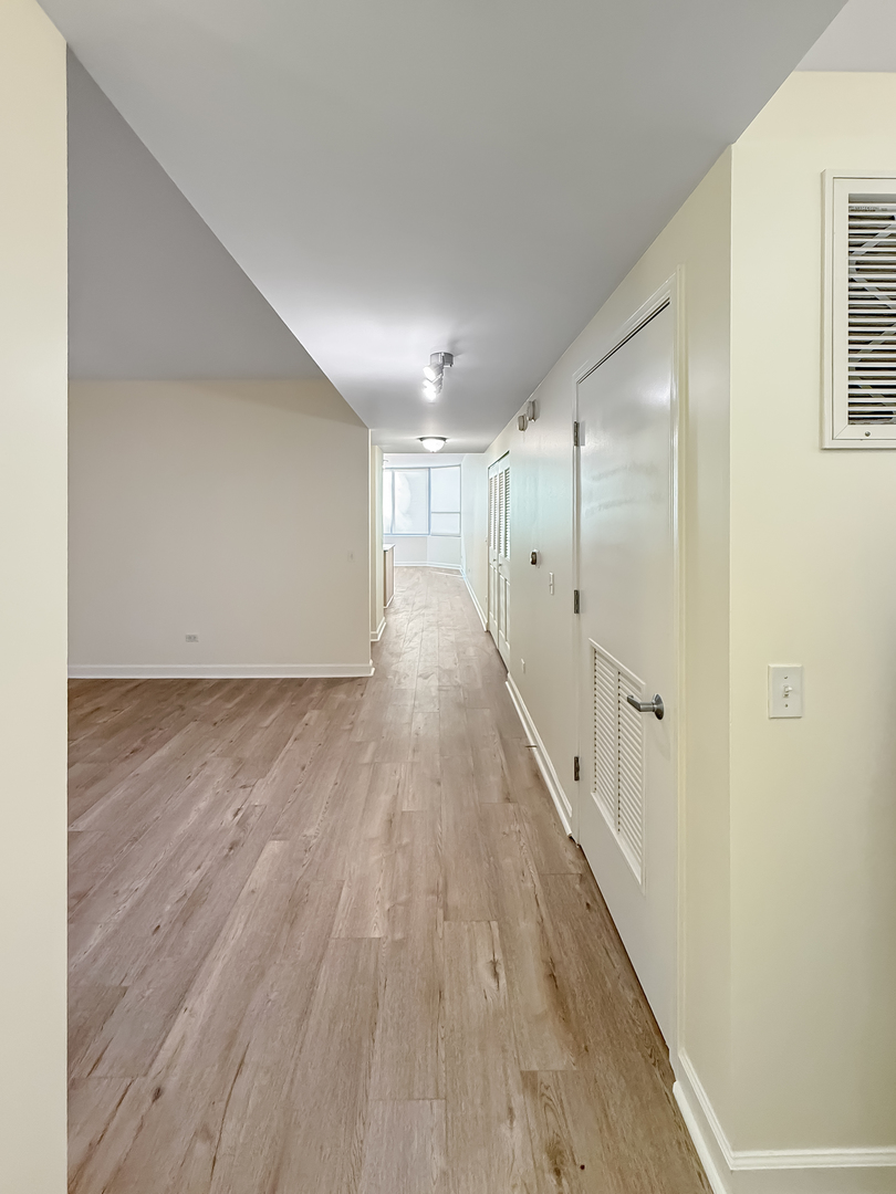 720 West Randolph Street, Unit 608 Chicago, IL 60661 - Photo 11 of 40 a view of a hallway with wooden floor