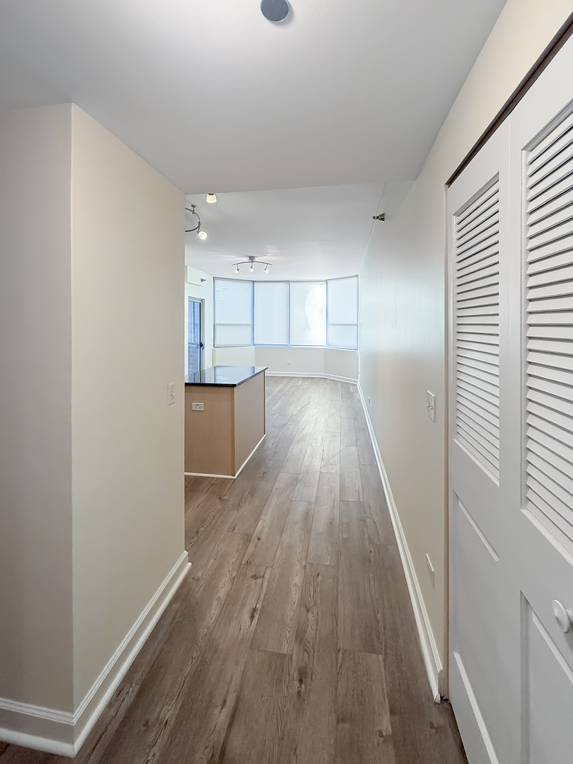 720 West Randolph Street, Unit 608 Chicago, IL 60661 - Photo 16 of 40 a view of a kitchen with a sink and wooden floor
