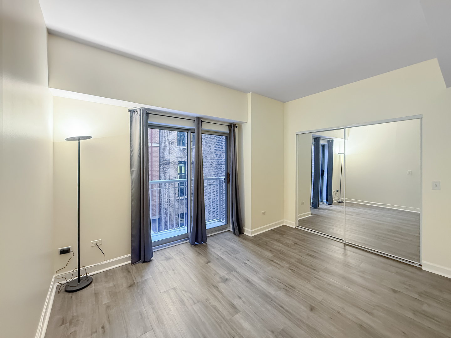 720 West Randolph Street, Unit 608 Chicago, IL 60661 - Photo 8 of 40 an empty room with wooden floor and windows