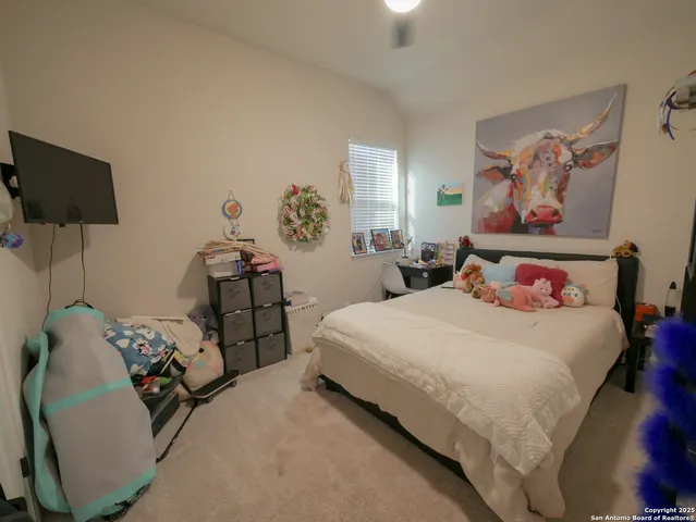 a bedroom with a bed and a ceiling fan