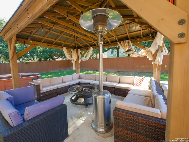 a living room with furniture a fireplace and a floor to ceiling window