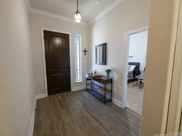 a kitchen with stainless steel appliances a dining table chairs stove refrigerator and cabinets