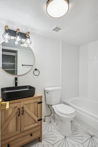 a side view of a house with a tree