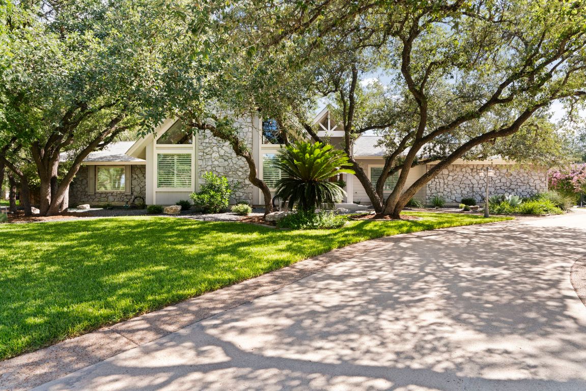 a front view of house with yard and green space