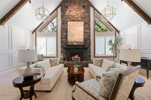 a living room with furniture fireplace and window