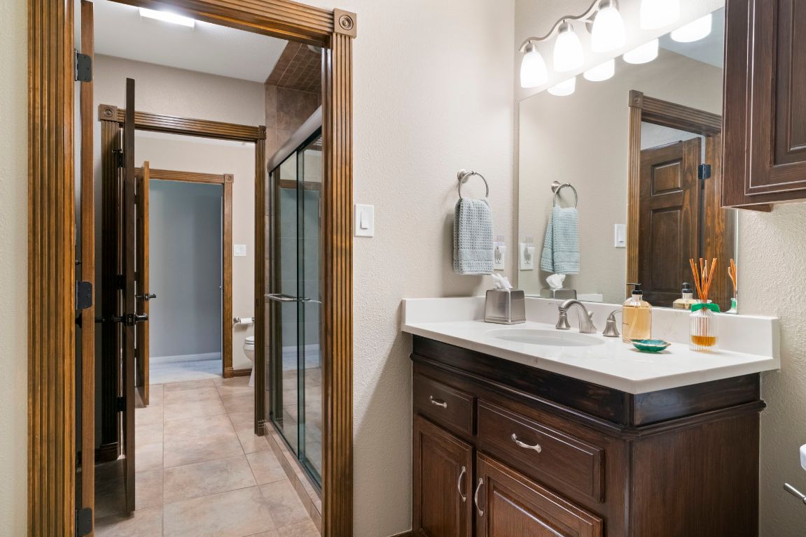2911 Gabriel View Drive Georgetown, TX 78628 - Photo 16 of 39 a bathroom with a sink vanity and mirror