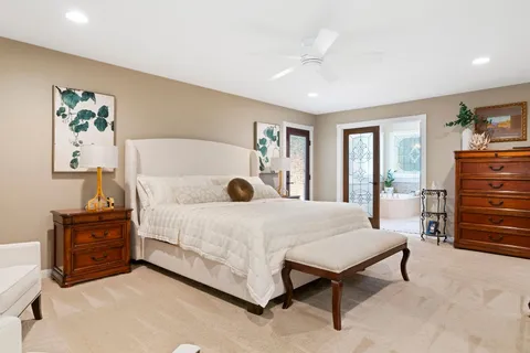 a spacious bedroom with a bed and a cabinets