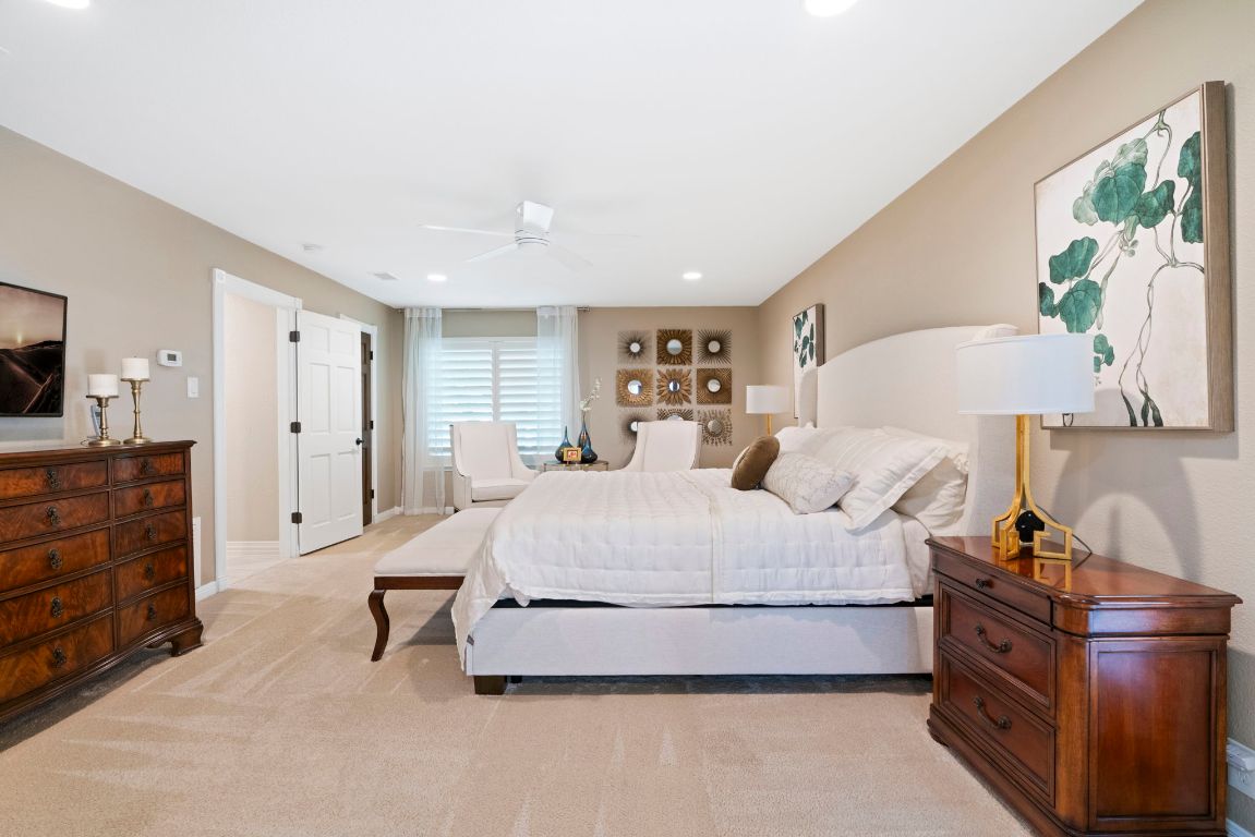 2911 Gabriel View Drive Georgetown, TX 78628 - Photo 21 of 39 a spacious bedroom with a bed and a lamp