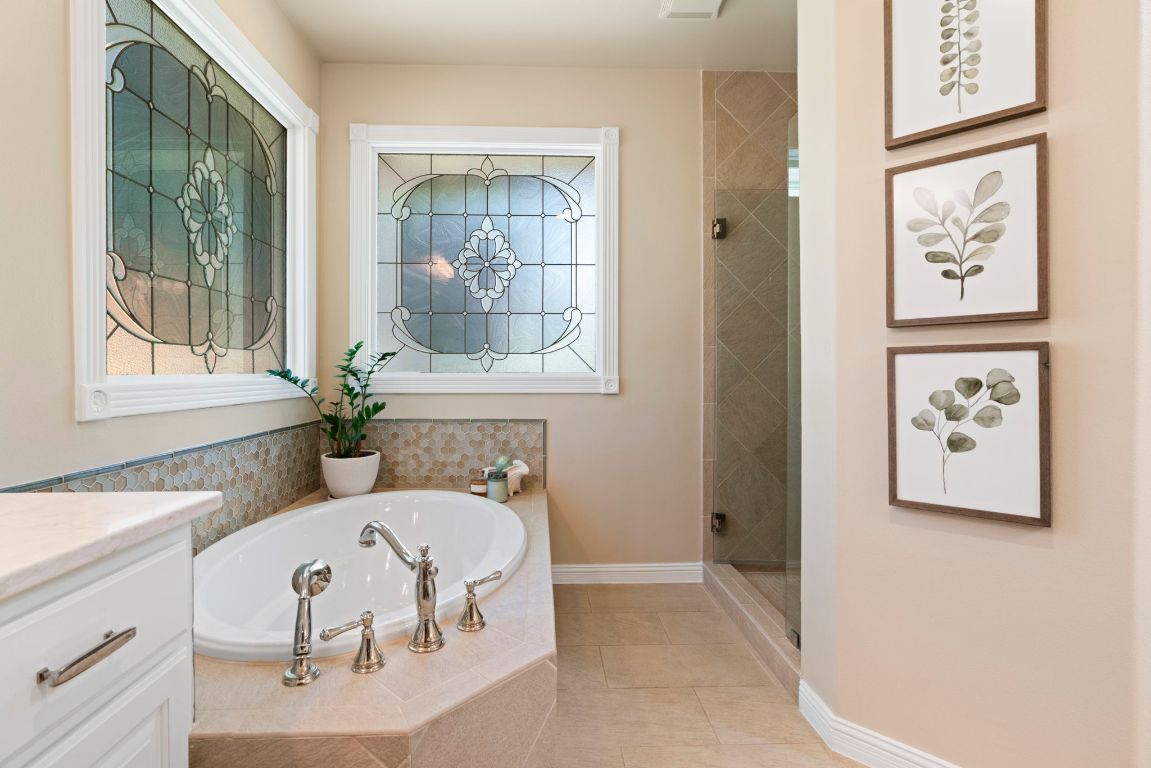 2911 Gabriel View Drive Georgetown, TX 78628 - Photo 23 of 39 a bathroom with a tub sink and mirror