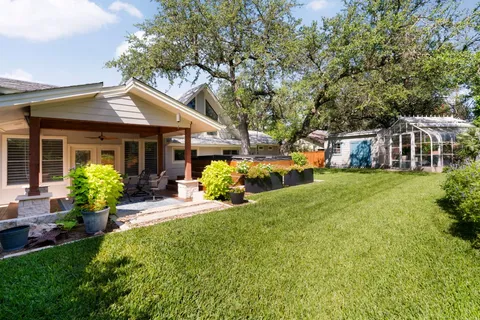 a view of a house with swimming pool and garden