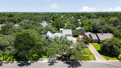 an aerial view of a house with a yard