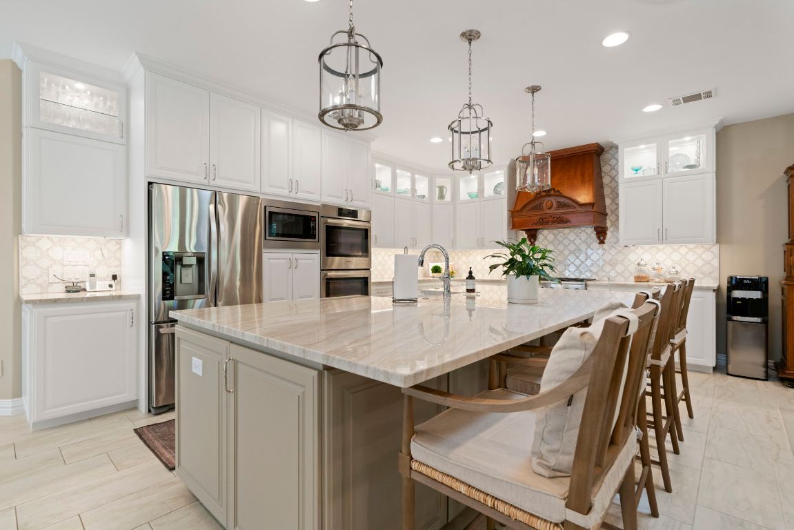 2911 Gabriel View Drive Georgetown, TX 78628 - Photo 8 of 39 a kitchen with stainless steel appliances granite countertop a kitchen island a table and chairs in it