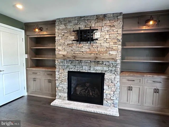 a kitchen with stainless steel appliances wooden floor and a sink
