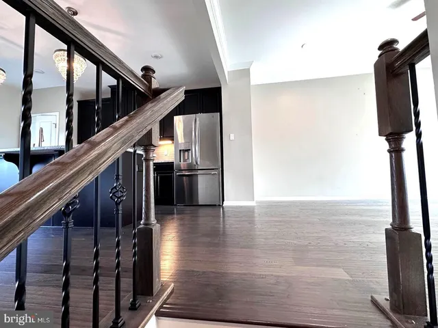 a view of a livingroom with wooden floor and a fireplace