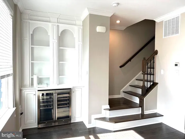 a view of a livingroom with a furniture wooden floor and chandelier