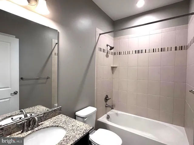 a bathroom with sinks granite countertop a sink and a window