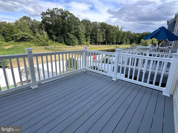 a view of balcony with wooden floor and fence