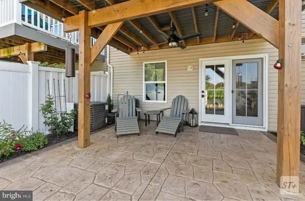 a view of a patio with table and chairs and potted plants