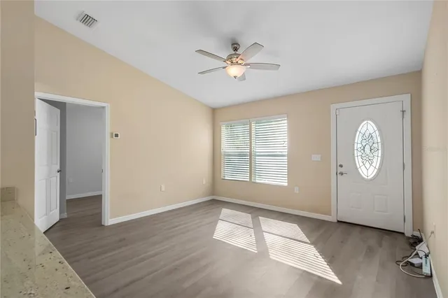 a view of empty room with wooden floor