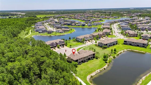 a large kitchen with a large counter top stainless steel appliances and cabinets